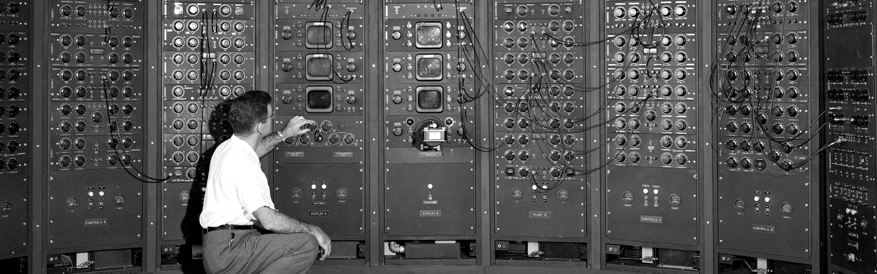 An operator at a fuel systems computer from the mid 20th century.
